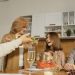 A multigenerational family enjoying a festive dinner indoors, sharing joy and togetherness.